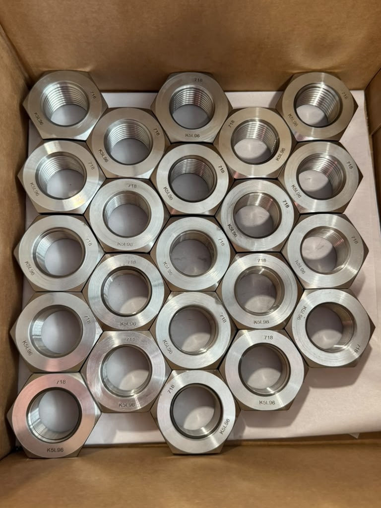 Inconel 718 heavy hex nuts with visible 718 markings packed in a carton