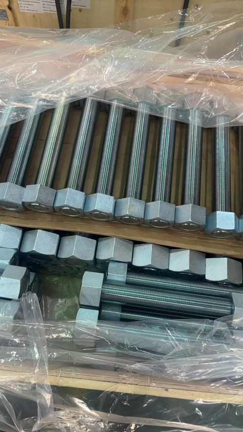 Zinc plated A193 B7 stud bolts with A194 2H heavy hex nuts laid out for packing