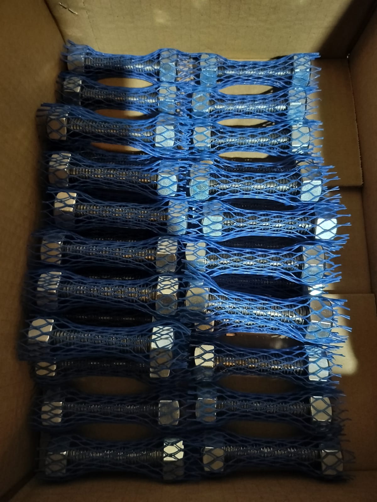 ASTM A193 B7 stud bolts with A194 2H heavy hex nuts in blue protective mesh sleeves