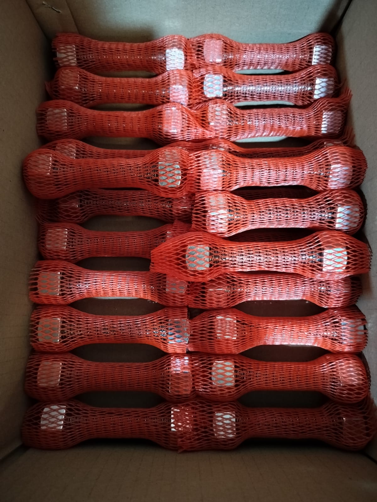 ASTM A193 B7 stud bolts with A194 2H nuts in red protective mesh sleeves packed for a gas plant shutdown
