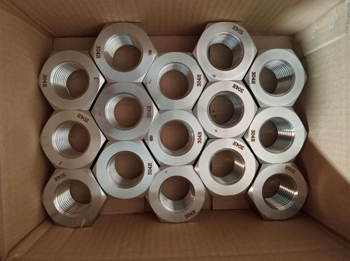 Heavy hex nuts staged for assembly with locking washers