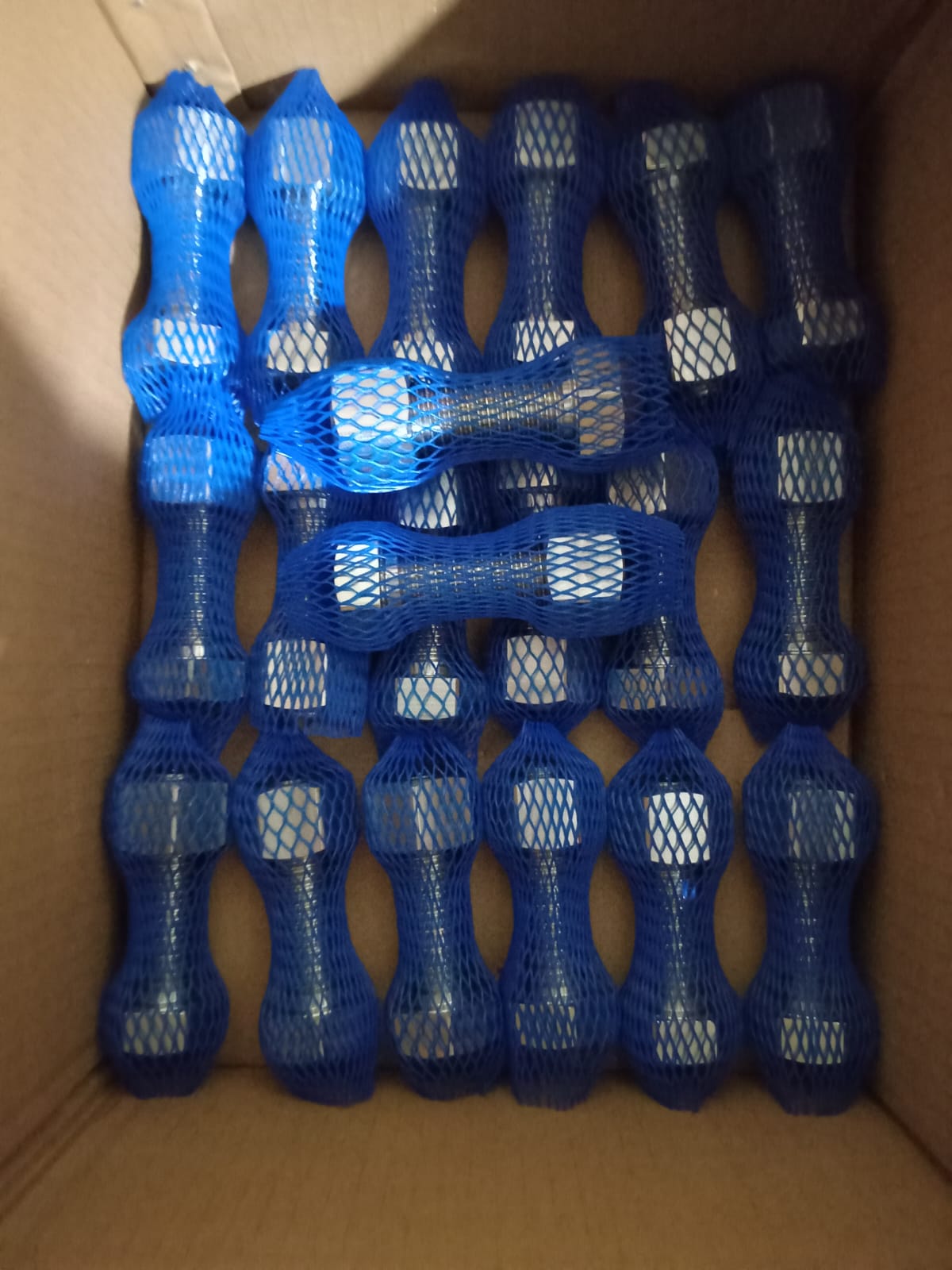 Industrial stud bolts packaged in protective blue mesh