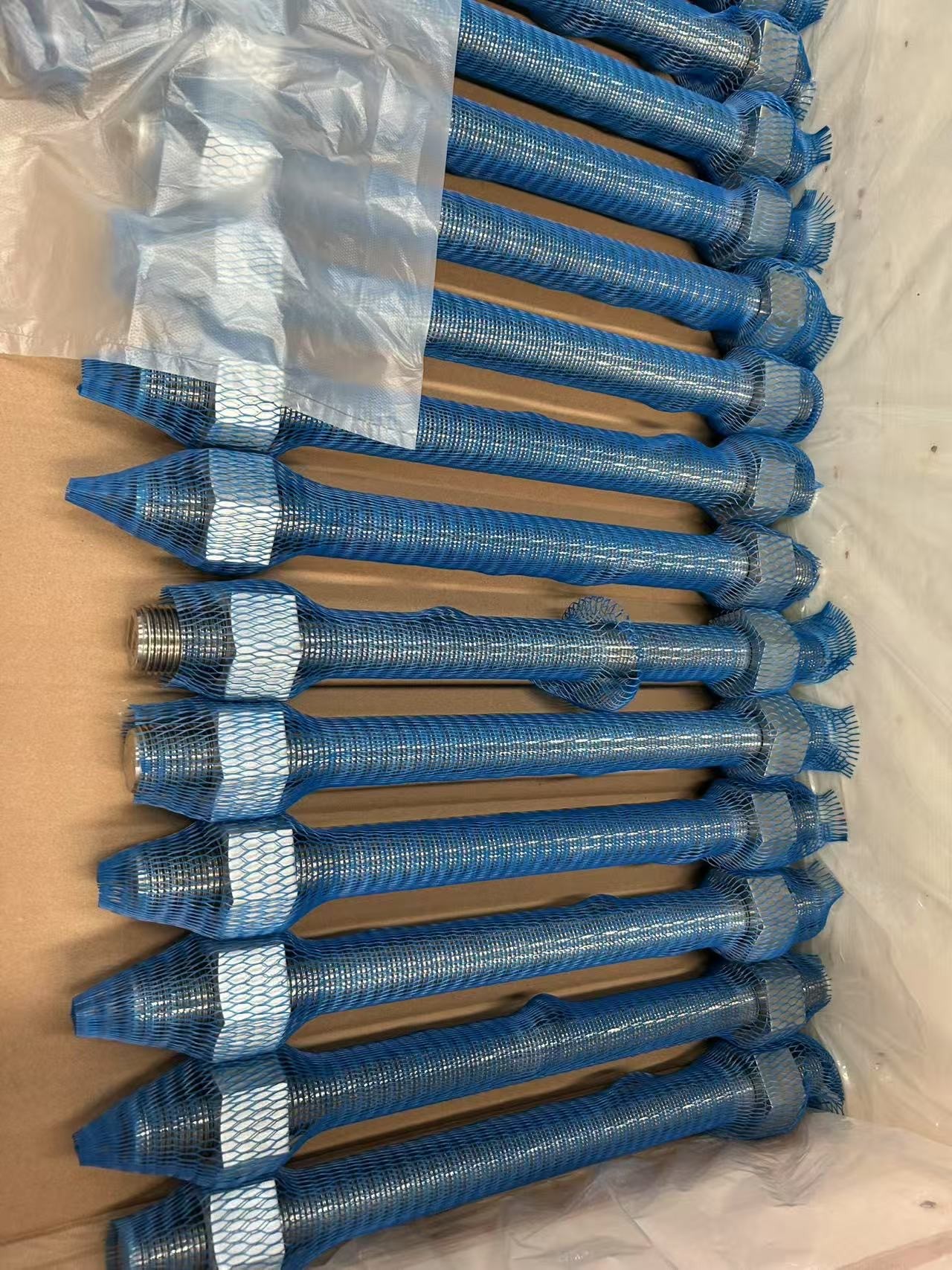 ASTM A453 Grade 660 stud bolts packed in protective blue mesh sleeves ready for dispatch