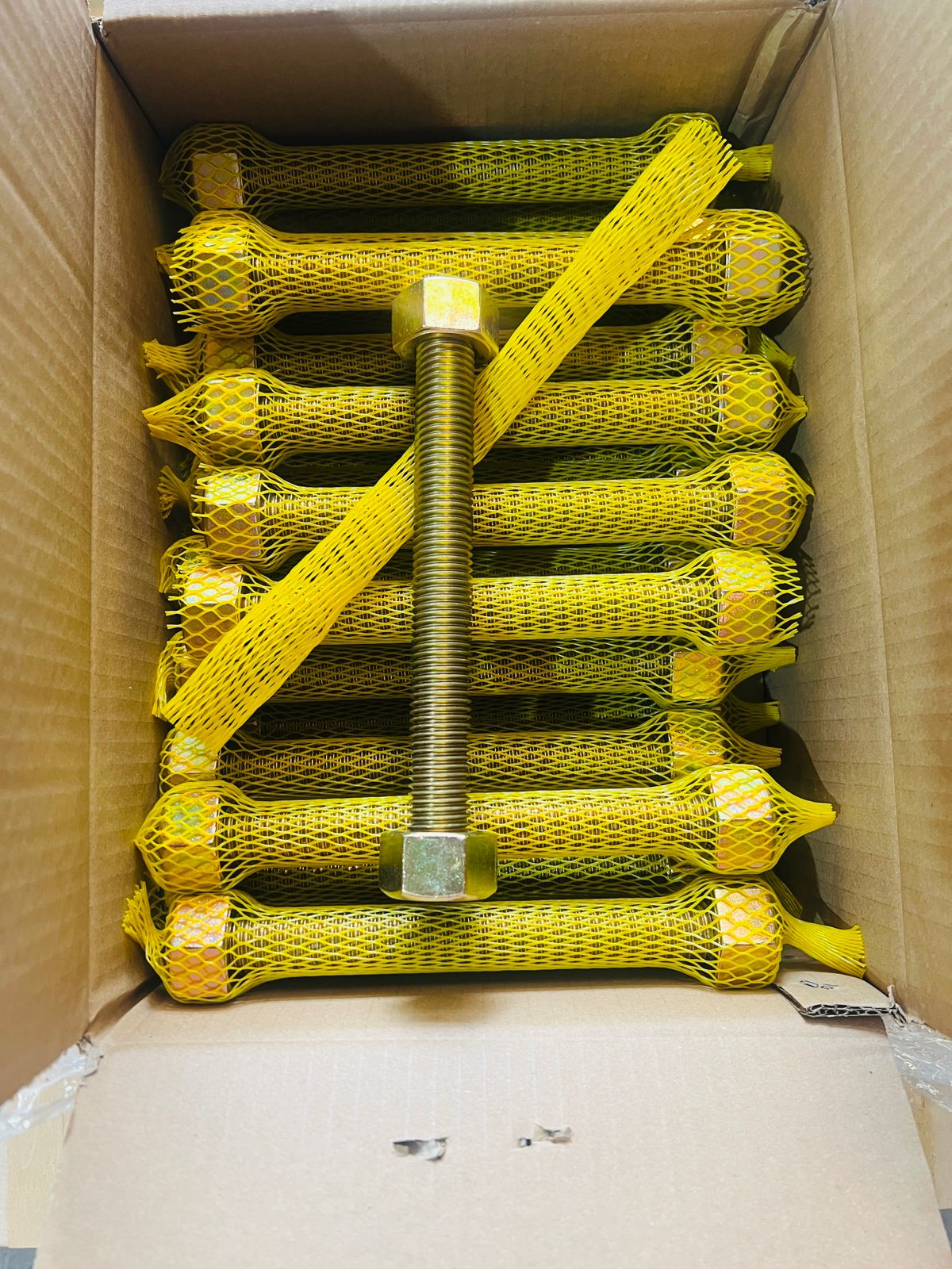 Zinc yellow trivalent coated ASTM A193 B7 stud bolts and A194 2H nuts in protective mesh sleeves